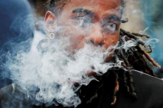 A demonstrator vapes during a protest at the Massachusetts State House against the state’s four-month ban of all vaping product sales in Boston, Massachusetts, U.S., October 3, 2019. REUTERS/Brian Snyder