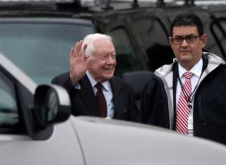 FILE PHOTO: Former U.S. President Jimmy Carter waves as he departs the Capitol after attending the presidential inauguration of Donald Trump in Washington, U.S., January 20, 2017. REUTERS/Mike Segar/File Photo