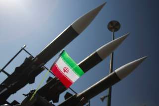 An Iranian flag is pictured next to Russian-made Sam-6 surface-to-air missiles during a war exhibition held by Iran's revolutionary guard to mark the anniversary of the Iran-Iraq war (1980-88), also known in Iran as the 