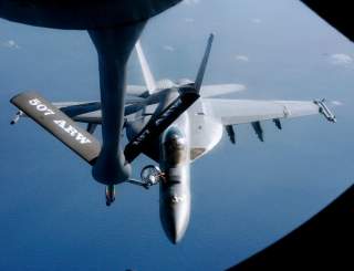 An FA-18 air fighter from the U.S. carrier George Washington is being refuelled by an air tanker over the Pacific near Okinawa Island, southern Japan, December 9, 2010. REUTERS/Kyodo (JAPAN - Tags: MILITARY TRANSPORT) JAPAN OUT. NO COMMERCIAL OR EDITORIAL