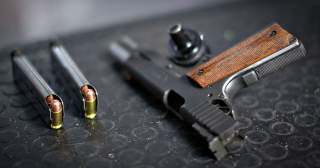 A 9mm pistol and ammunition sits ready for the next customer at the DVC Indoor Shooting Centre in Port Coquitlam, British Columbia March 22, 2013. REUTERS/Andy Clark (CANADA)