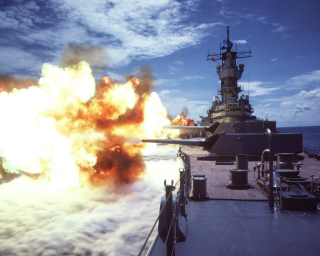  330-CFD-DN-ST-86-02454: The battleship USS Iowa (BB 61) fires a broadside to starboard from its Mk 7 16-inch guns, 7/1/1984. PH1 Jeff Hilton, USN. (OPA-NARA II-2016/01/07).