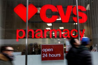 FILE PHOTO: People walk by a CVS Pharmacy store in the Manhattan borough of New York City, New York, U.S., November 30, 2017. REUTERS/Shannon Stapleton/File Photo