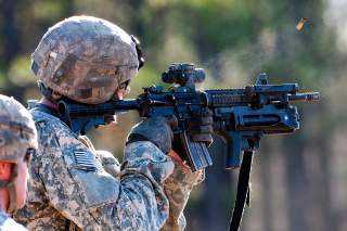 Army Pvt. Brian Spedding fires at a pop-up target during the Bandit Blitz team competition on Fort Bragg, N.C., Dec. 1, 2011. Spedding is an artilleryman assigned to the 82nd Airborne Division's 1st Brigade Combat Team