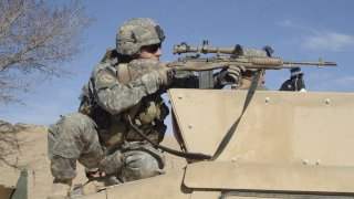 U.S. Army Sgt. Colin Cleek, from Reconnaissance Platoon, 2nd Battalion, 508th Parachute Infantry Regiment, looks through the scope of his rifle onto a mortar range near Ghazni, Afghanistan, on April 1, 2007.   DoD photo by Staff Sgt. Michael L. Casteel, U