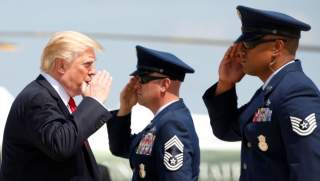 U.S. President Donald Trump returns a salute while boarding Air Force One as he departs Joint Base Andrews in Maryland, U.S., August 30, 2017. REUTERS/Kevin Lamarque