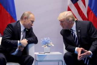 Russia's President Vladimir Putin talks to U.S. President Donald Trump during their bilateral meeting at the G20 summit in Hamburg, Germany, July 7, 2017. REUTERS/Carlos Barria//File Photo