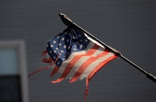 Tattered American flag flies across the street from Wyckoff Heights Medical Center during outbreak of coronavirus disease (COVID-19) in New York