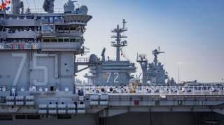 NORFOLK (April 11, 2018) Sailors aboard the aircraft carrier USS Harry S. Truman (CVN 75) man the rails during departure for the ship's 2018 deployment.