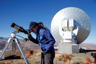 A scientist looks at the sun through a telescope before of the solar eclipse in La Silla European Southern Observatory (ESO) at Coquimbo, Chile July 2, 2019. REUTERS/Rodrigo Garrido