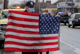 Townspeople line the route to the cemetery as the hearse carrying Vietnam and Korean Wars Air Force veteran Mary Foley, who died with no living family members and who could not have a full military funeral because of restrictions due to the coronavirus di