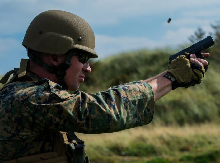 Sgt. Devin Hughes, a member of the Marine Corps Shooting Team, fires a round at a target during the Royal Marines Operational Shooting Competition at Altcar Range near Hightown, England, Sept. 8, 2014. (U.S. Marine Corps photo by Cpl. Cameron Storm/Releas