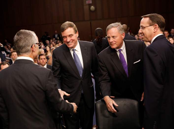 Sen. Mark Warner (D-VA, 2-L) and Sen. Richard Burr (R-NC, 2-R) greet Acting FBI Director Andrew McCabe (L) and Deputy Attorney General Rod Rosenstein (R) as they arrive to testify before a Senate Intelligence Committee hearing on Capitol Hill