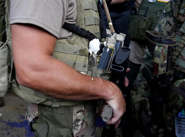 A militia member has an egg on his body armor during rally in Charlottesville, Virginia, U.S., August 12, 2017. REUTERS/Joshua Roberts