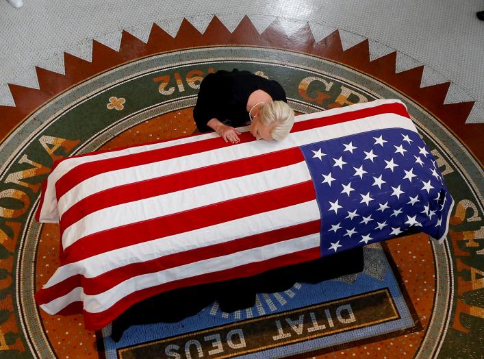 Cindy McCain, wife of U.S. Senator John McCain, touches the casket during a memorial service at the Arizona Capitol in Phoenix, Arizona, U.S., August 29, 2018. Ross D. Franklin/Pool via REUTERS