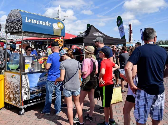 Feb 17, 2019; Daytona Beach, FL, USA; Fans line up at a lemonade stand prior to the Daytona 500 at Daytona International Speedway. Mandatory Credit: Jasen Vinlove-USA TODAY Sports