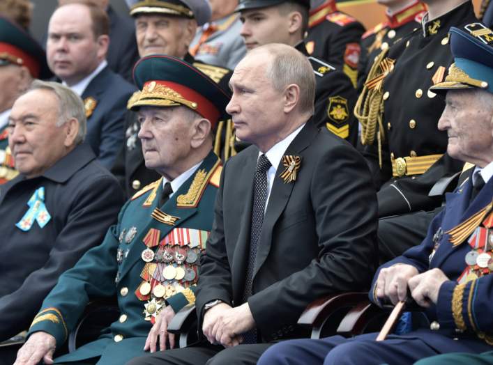 Spectators, including Russia's President Vladimir Putin and Kazakhstan's Former President Nursultan Nazarbayev, attend the Victory Day parade, which marks the anniversary of the victory over Nazi Germany in World War Two, in Red Square in central Moscow, 