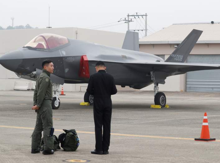 A South Korean fighter pilot (L) stands next to his F-35 stealth fighter during a ceremony to mark the 71st Armed Forces Day at the Air Force Base in Daegu, South Korea, October 1, 2019. Jeon Heon-kyun/Pool via REUTERS