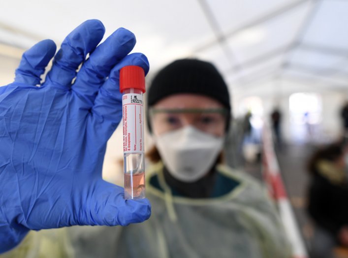 A medical employee presents a smear taken at a special corona test center for public service employees such as police officers, nurses and firefighters during a media presentation as the spread of the coronavirus disease (COVID-19) continues, in Munich, G