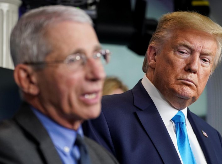 U.S. President Donald Trump listens as Dr. Anthony Fauci, director of the National Institute of Allergy and Infectious Diseases, addresses the daily coronavirus task force briefing at the White House in Washington, U.S., April 7, 2020. REUTERS/Kevin Lamar