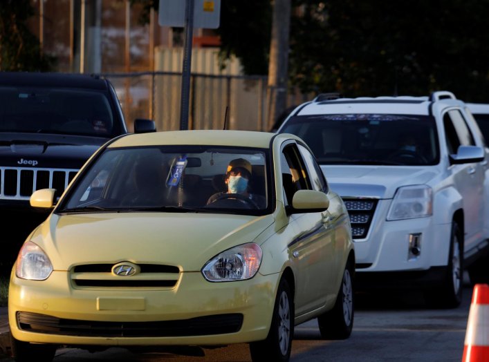 People in cars wait in line to pick up unemployment forms, as the outbreak of coronavirus disease (COVID-19) continues, in Hialeah, Florida, U.S., April 8, 2020. REUTERS/Marco Bello