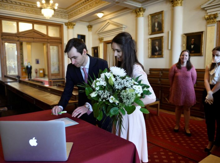 Roxanne, 25, a French lawyer working in Belgium, and Nicolas, 28, a real estate agent, attend their wedding ceremony despite the coronavirus disease (COVID-19) outbreak, in Brussels, Belgium April 11, 2020. Only the witnesses were allowed to the ceremony.