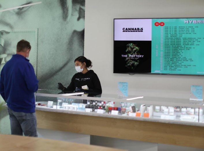 Ashlee Mason, 26, serves a customer at The Pottery Cannabis Dispensary, as marijuana deliveries increase amid the spread of the coronavirus disease (COVID-19), in Los Angeles, California, U.S., April 14, 2020. REUTERS/Lucy Nicholson