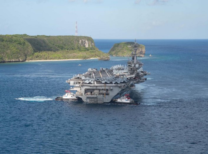 The U.S. Navy aircraft carrier USS Theodore Roosevelt departs following an extended visit in the midst of a coronavirus disease (COVID-19) outbreak, from Apra Harbor, Guam May 21, 2020. Picture taken May 21, 2020. U.S. Navy/Mass Communication Specialist S