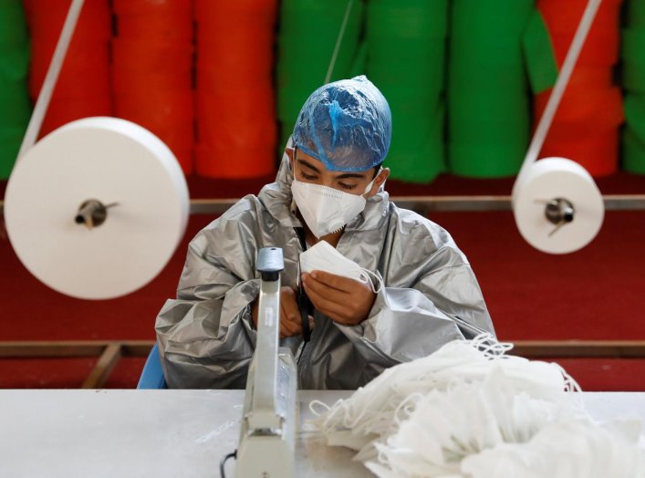 A man wears a protective face mask as he works at a mask factory, during the coronavirus disease (COVID-19) outbreak in Kabul, Afghanistan July 2, 2020. REUTERS/Mohammad Ismail