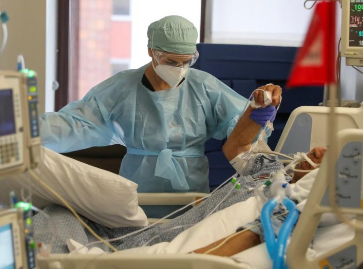 Co-director of the intensive care unit at CommonSpirit's Dignity Health California Hospital Medical Center, Dr. Zafia Anklesaria, 35, who is seven months pregnant, attends to a COVID-19 patient in the hospital where she works, during the coronavirus disea