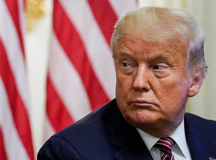 U.S. President Donald Trump listens during a coronavirus disease (COVID-19) pandemic response event about reopening schools in the State Dining Room at the White House in Washington, U.S., August 12, 2020. REUTERS/Kevin Lamarque