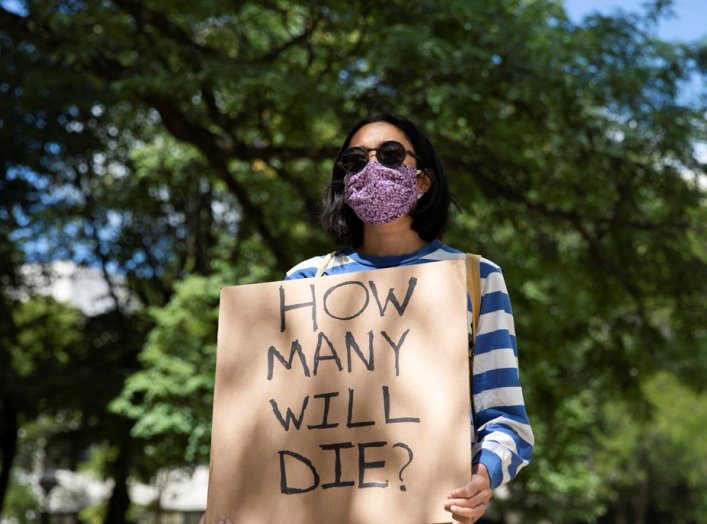 Faculty member protests in-person classes for fall semester amid the coronavirus disease (COVID-19) pandemic, outside Fleming Administrative Building at the University of Michigan campus in Ann Arbor, Michigan, U.S., August 19, 2020. REUTERS/Emily Elconin