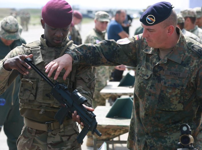 A German soldier with the 291st Infantry Division (right), explains the functions of the MP7-PDW to a British soldier (left) assigned to 2nd Parachute Regiment, Vaziani Airfield, Republic of Georgia, July 30, 2017. U.S. Army/Joseph E. Cannon.