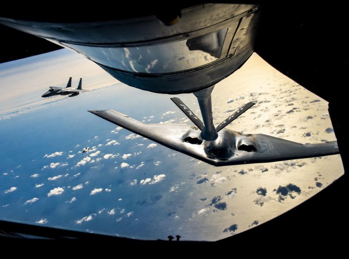 A B-2 Spirit Stealth Bomber from the 509th Bomb Wing, Whiteman Air Force Base, Missouri, flies behind a KC-135 Stratotanker from the 100th Air Refueling Wing, RAF Mildenhall, England, during a training mission for Bomber Task Force Europe over England on 