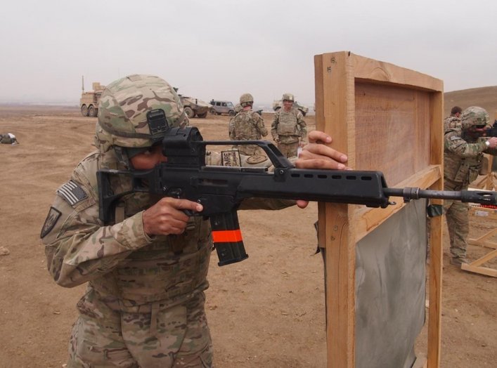 Pfc. Simeon Taylor, with Bravo Company, 427th Brigade Support Battalion, fires the German made Heckler & Koch G36 assault rifle during the qualification for the schützenschnur badge, at the German marksmanship range, on Nov. 17 in Mazare-e Sharif, Afghani