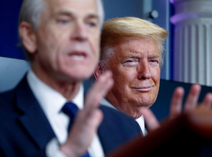 U.S. President Donald Trump listens as White House Director of Trade and Marketing Policy Peter Navarro addresses the daily coronavirus response briefing at the White House in Washington, U.S., April 2, 2020. REUTERS/Tom Brenner