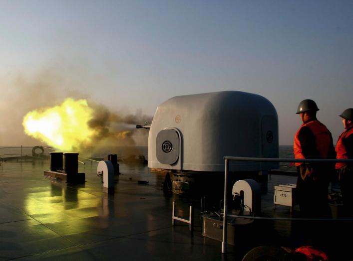 A battleship fires during an exercise on the East China Sea February 2, 2007. Picture taken February 2, 2007. CHINA OUT REUTERS/China Daily