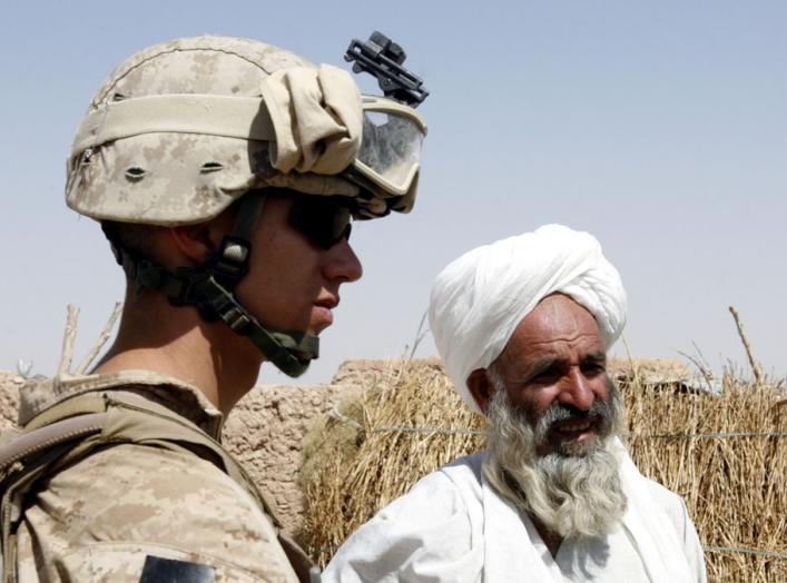 A U.S. Marine from 2nd platoon, F company, 5th batalion, 10th Marines, meets an Afghan villager during a patrol in southern Afghanistan June 28, 2009. After five years coping with the most dangerous province in Iraq, the U.S. Marines have been given their