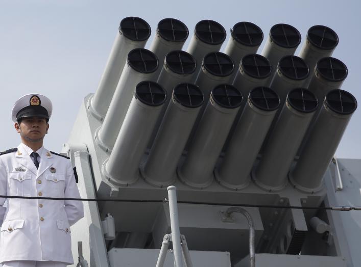 A Chinese People's Liberation Army (PLA) Navy personnel stands on the deck of the Chinese naval guided missile destroyer Haikou (171) during a welcome ceremony as it docks at the Ngong Shuen Chau Naval Base in Hong Kong April 30, 2012.