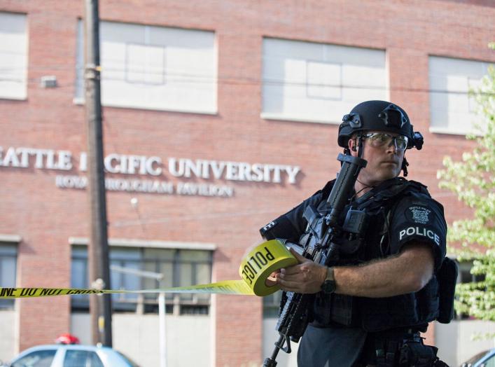 A policeman secures the scene at Seattle Pacific University after the campus was evacuated due to a shooting in Seattle, Washington June 5, 2014. A gunman opened fire on Thursday on the campus of a small Christian college in Seattle, killing one person an