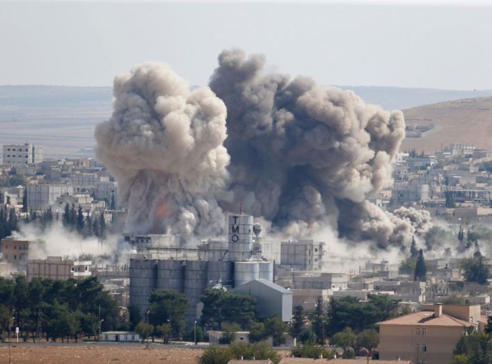 Smoke rises after an U.S.-led air strike in the Syrian town of Kobani Ocotber 8, 2014. U.S.-led air strikes on Wednesday pushed Islamic State fighters back to the edges of the Syrian Kurdish border town of Kobani, which they had appeared set to seize afte