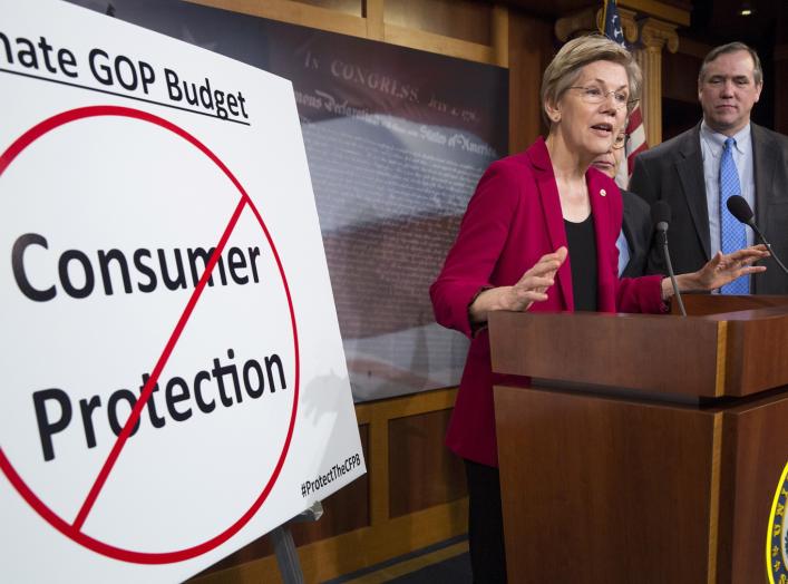 Senators Elizabeth Warren (D-MA), Al Franken (hidden)(D-MN) and Jeff Merkley (D-OR) hold a news conference to warn about the abolishment of Consumer Financial Protection Bureau in the proposed budget put forward by Senate Republicans on Capitol Hill