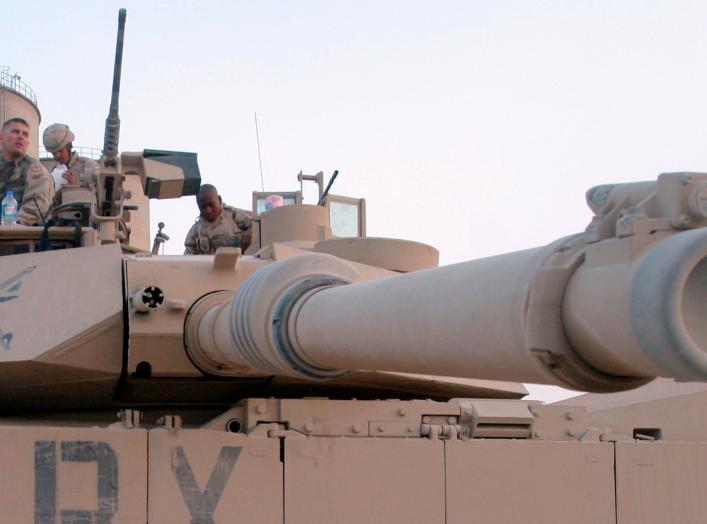 U.S. troops sit on an Abrams M1 tank as they prepare to join a military offensive in the northern Iraq city of Tal Afar September 10, 2005.