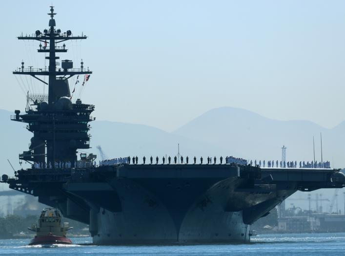 The aircraft carrier USS Theodore Roosevelt, with sailors manning the rails, leaves port on deployment to the western Pacific Ocean and Persian Gulf from San Diego, California, U.S., October 6, 2017. REUTERS/Mike Blake