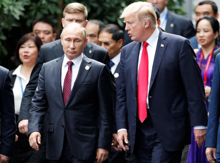 U.S. President Donald Trump and Russia's President Vladimir Putin talk during the family photo session at the APEC Summit in Danang, Vietnam November 11, 2017.