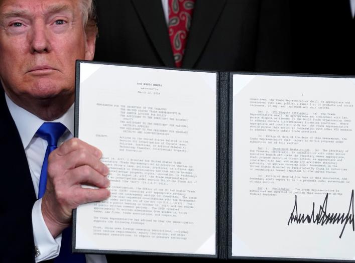 U.S. President Donald Trump holds a signed memorandum on intellectual property tariffs on high-tech goods from China, at the White House in Washington, U.S. March 22, 2018. REUTERS/Jonathan Ernst