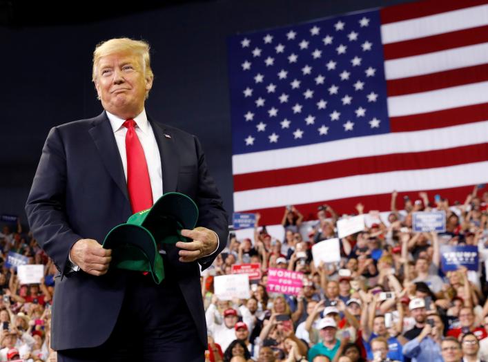 U.S. President Donald Trump holds "Make Our Farmers Great Again!" hats as he arrives for a "Make America Great Again" rally in Evansville, Indiana, U.S. August 30, 2018. REUTERS/Kevin Lamarque