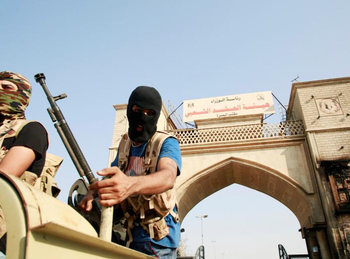 Iraqi Popular Mobilization Forces members guard near the building belonging to a Popular Mobilization Forces in Basra, Iraq September 8, 2018. REUTERS/Alaa al-Marjani