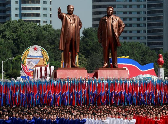 People carry flags in front of statues of North Korea founder Kim Il Sung (L) and late leader Kim Jong Il during a military parade marking the 70th anniversary of North Korea's foundation in Pyongyang, North Korea, September 9, 2018. REUTERS/Danish Siddiq