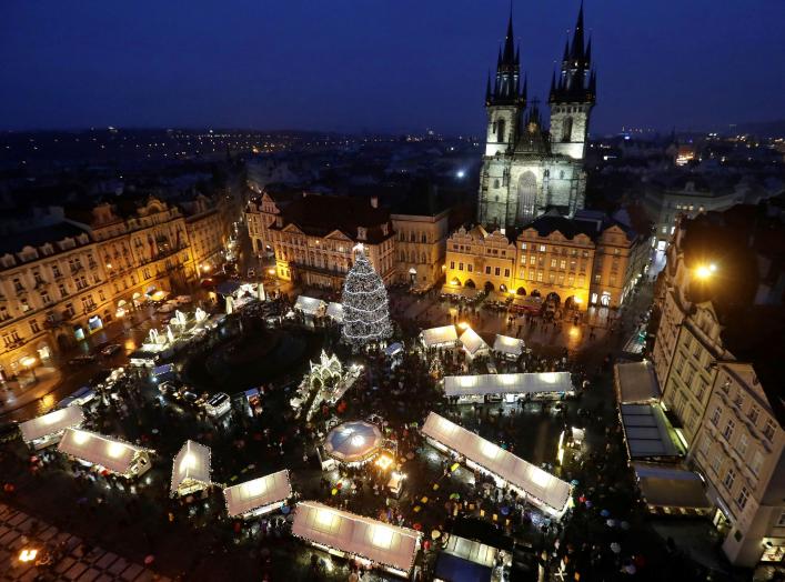 A Christmas tree is illuminated as people visit the traditional Christmas market at the Old Town Square in Prague, Czech Republic, December 2, 2018. REUTERS/David W Cerny